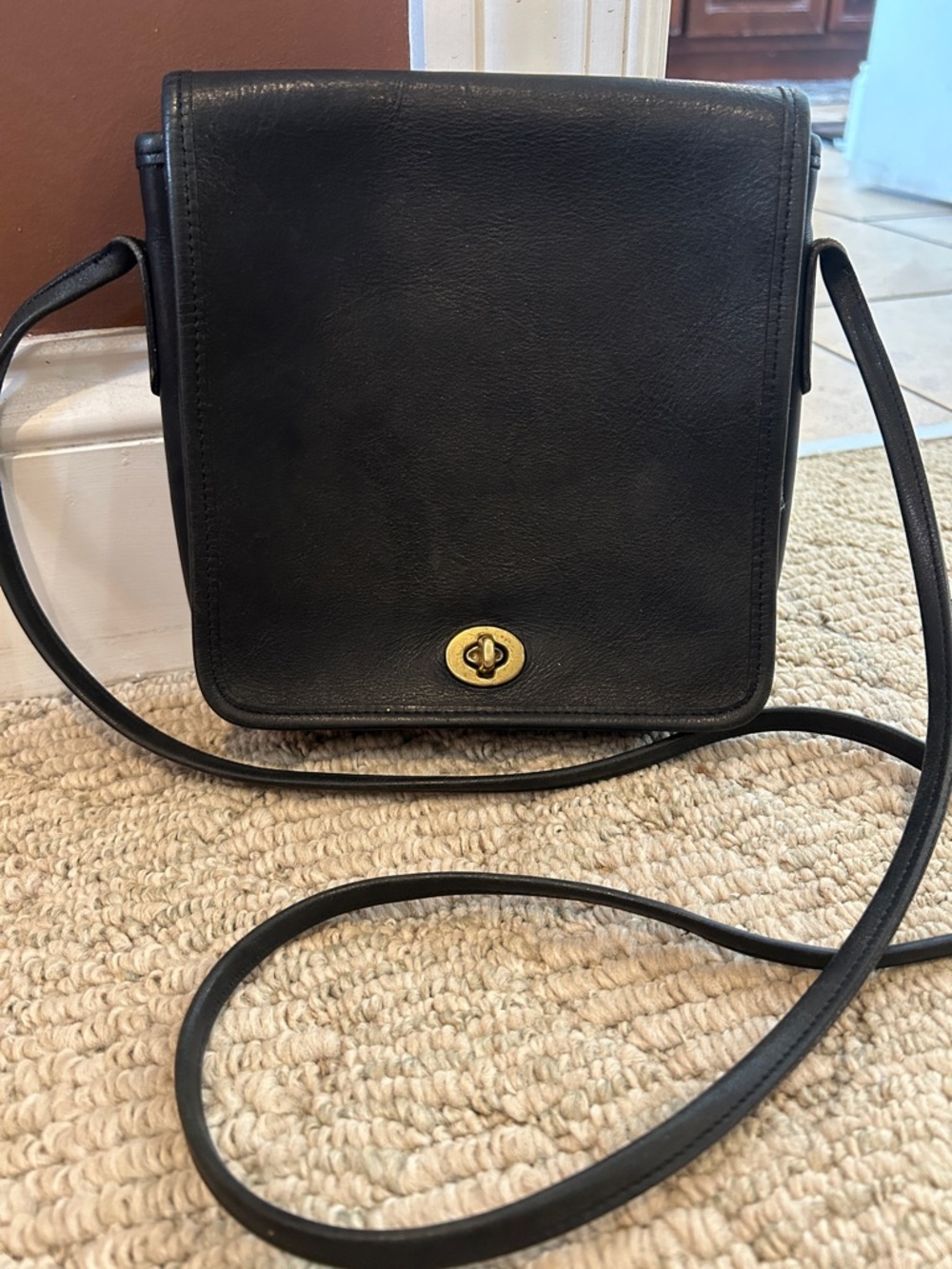 Coach- Vintage Black Leather Crossbody Bag with Turn-Lock Closure